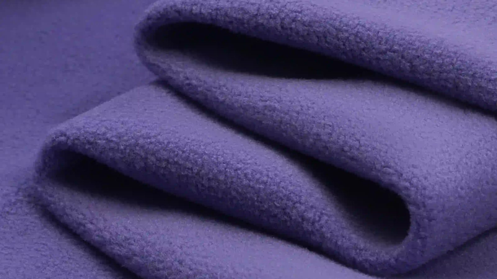 Side view of folded fleece fabric showing thickness and brushed surface