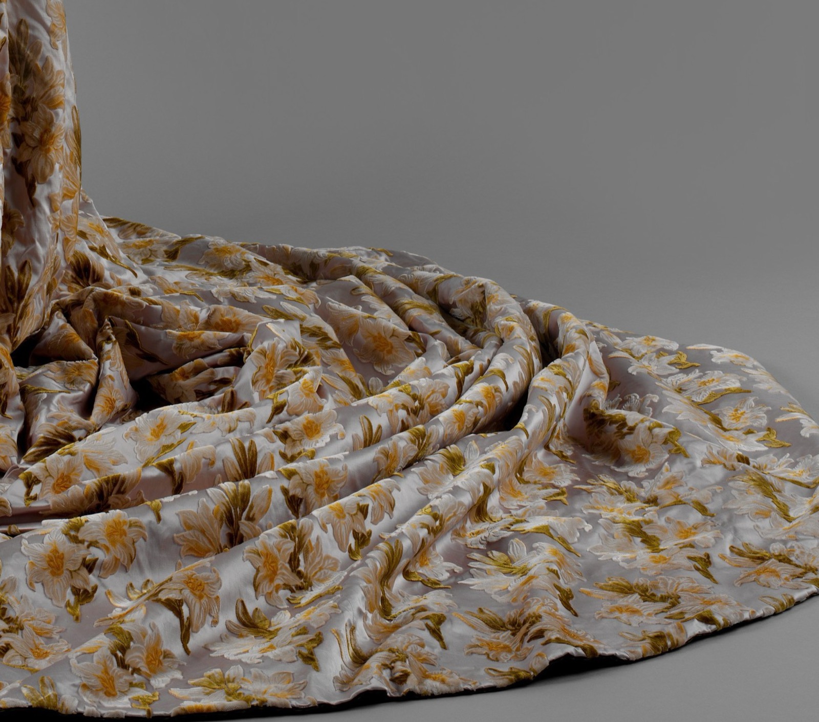 Close view of pale floral devoré silk velvet on the train, showing flower and leaf motifs against a paler ground