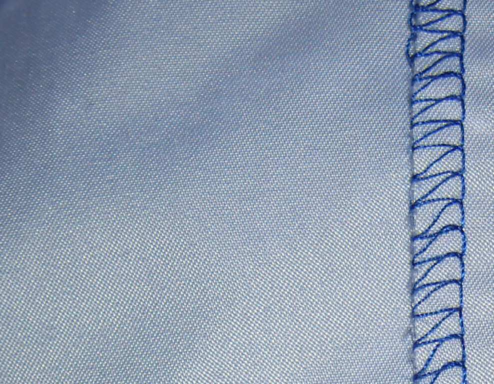 Close-up of a light blue shirt documented by its photographer as 100 percent polyester
