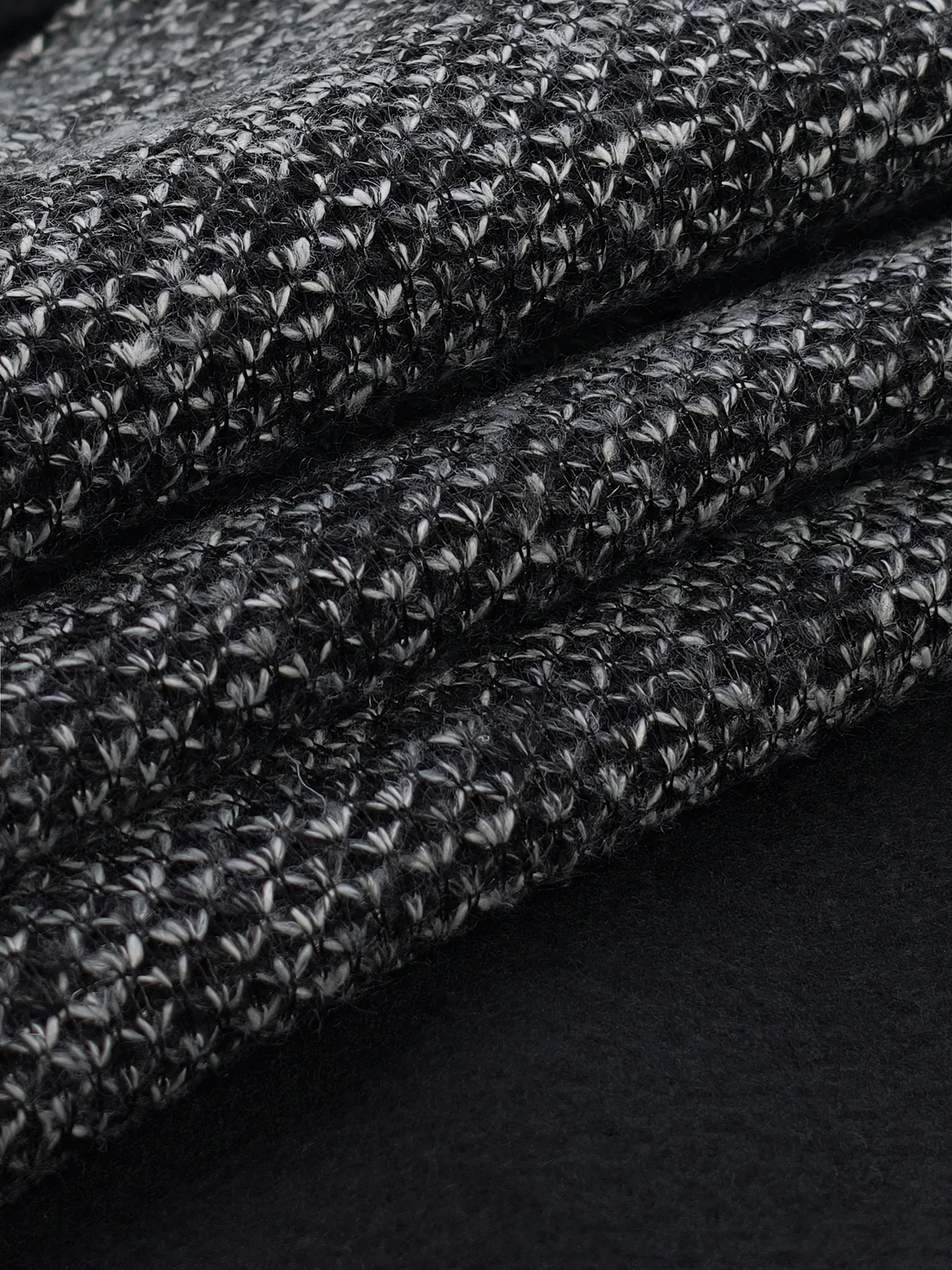 Close folded view of one WellDoneTex bonded-fabric sample with contrasting face and backing